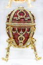 Ornate red and gold Faberge egg souvenir in the official store at Faberge museum for tourists in Saint Petersburg Russia Royalty Free Stock Photo