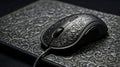 Ornate silver computer mouse resting on a patterned silver surface Royalty Free Stock Photo