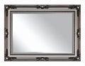 Ornate Silver Framed Mirror Reflecting Light In an Elegant Room Setting Royalty Free Stock Photo