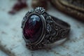 Ornate silver ring featuring a large purple gemstone, showcasing craftsmanship and luxurious design Royalty Free Stock Photo