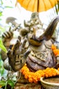 An ornate statue of Ganesha with a swastika on his hand