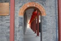 Ornate stone archway decorated by red lanterns in Beijing, China