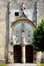 Ornate stone portal and door of a medieval church in Champagne
