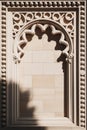 Ornate Stone Window Frame with Carved Details in Sunlight Royalty Free Stock Photo