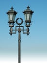 Ornate street lamp on blue sky