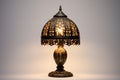 an ornate table lamp against a plain, off-white background Royalty Free Stock Photo