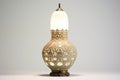 an ornate table lamp against a plain, off-white background Royalty Free Stock Photo