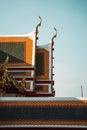 Ornate temple roof against the blue sky. Bangkok, Thailand.