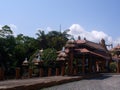 Ornate tiled building facade with sculptural details of traditional East Asian architecture serves as tourist attraction