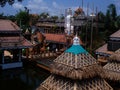 Ornate tiled building with sculptural details of traditional East Asian undergoing repairs