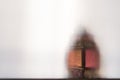 An ornate, vintage table lamp, Shot through a semi transparent material. Creating a textured, blurred beautiful still life