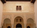 Ornate wall with arches and windows of Nasrid Palace , Alhambra, Spain