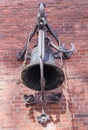 An ornate, weathered bell mounted on a brick wall Royalty Free Stock Photo