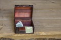 Ornate wooden tip box with American dollars sitting on the edge of rustic wooden stage