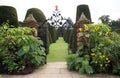 Ornate wrought iron garden gate with unicorn sculpture