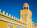 Ornate yellow wall and minaret in Melilla