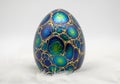 Ornately decorated egg resembling a dragon egg, featuring a smooth, iridescent surface with vibrant Royalty Free Stock Photo