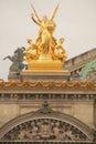 Ornately detailed golden statue of the Garnier Palace located in the heart of Paris, France