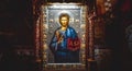 Ornately framed, enameled and gilded picture of Jesus depicted holding a book with Greek letteres Royalty Free Stock Photo