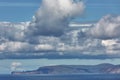 Orney cliffs with dramatic sky seen from John o`Groats over Atlantic ocean Royalty Free Stock Photo