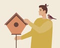 Man hanging birdhouse, ornithological flat vector stock illustration with birds as nature care concept