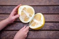 Oroblanco Citrus Sweetie, a pomelo lies cut in half on a wooden cutting board Royalty Free Stock Photo