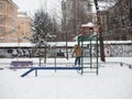 Orphan child alone in the playground in winter, graffiti background Royalty Free Stock Photo