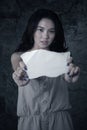 Orphan girl shows empty paper