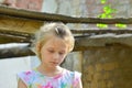 The orphan girl was left homeless and standing near the ruins of the building as a result of a military conflict, a fire and an ea Royalty Free Stock Photo