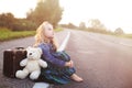 Orphan sits alone on the road Royalty Free Stock Photo