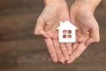 Orphanage, children in the orphanage. The child is holding a small house-shaped figurine, close-up. Adoption concept