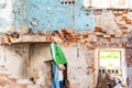 Orphaned children, poor child standing in a destroyed and abandoned building, staged photo