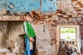 Orphaned children, poor child standing in a destroyed and abandoned building, staged photo