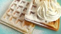 ÃÂ¡orrugated waffles, sprinkled with icing sugar and decorated with cream