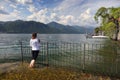 ORTA SAN GIULIO, ITALY - 10 MAY, 2018 - Young girl tourist admiring Orta LAke