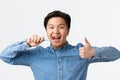 Orthodontics, dental care and hygiene concept. Close-up of satisfied happy asian man brushing teeth with braces, holding Royalty Free Stock Photo