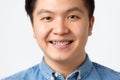 Orthodontics and stomatology concept. Headshot of happy asian man smiling, showing dental braces, recommend clinic