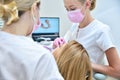 Orthodontist and assistant scaning patient`s teeth with 3d scanner