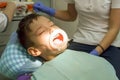 Orthodontist examining boy mouth