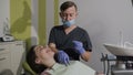 An orthodontist wearing elastic braids. Healthy teeth. Good smile of the patient