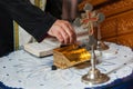 Orthodox baptism in the church hand of a priest takes the holy oil for baptism