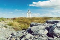 Orthodox chapel white with a transparent facade on the background of the panorama of the sea and blue sky in a field Royalty Free Stock Photo