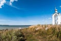 Orthodox chapel white with a transparent facade on the background of the panorama of the sea and blue sky in a field Royalty Free Stock Photo