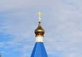 Orthodox Christian church with blue roof, golden dome and cross in Russia. A building for religious ceremonies with a bell tower Royalty Free Stock Photo