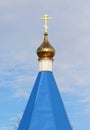 Orthodox Christian church with blue roof, golden dome and cross in Russia. A building for religious ceremonies with a bell tower Royalty Free Stock Photo