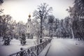 Orthodox Christian church in winter snowy park during winter season with snowy covered trees and way alley leading to church Royalty Free Stock Photo