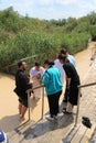 Orthodox Christian pilgrims as a part of a traditional baptism ceremony in the Jordan River Royalty Free Stock Photo