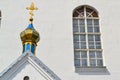Orthodox church in Belarus, details of bell tower with snow white wall and arched stained glass window. Close up image Royalty Free Stock Photo