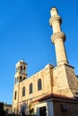 Orthodox church with a bell tower and a minaret in the town of Chania on the island of Crete Royalty Free Stock Photo