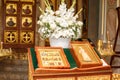 Orthodox Church candles with icons, the Bible and the cross